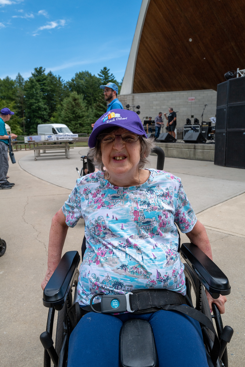 A woman in a wheelchair at an outdoor event