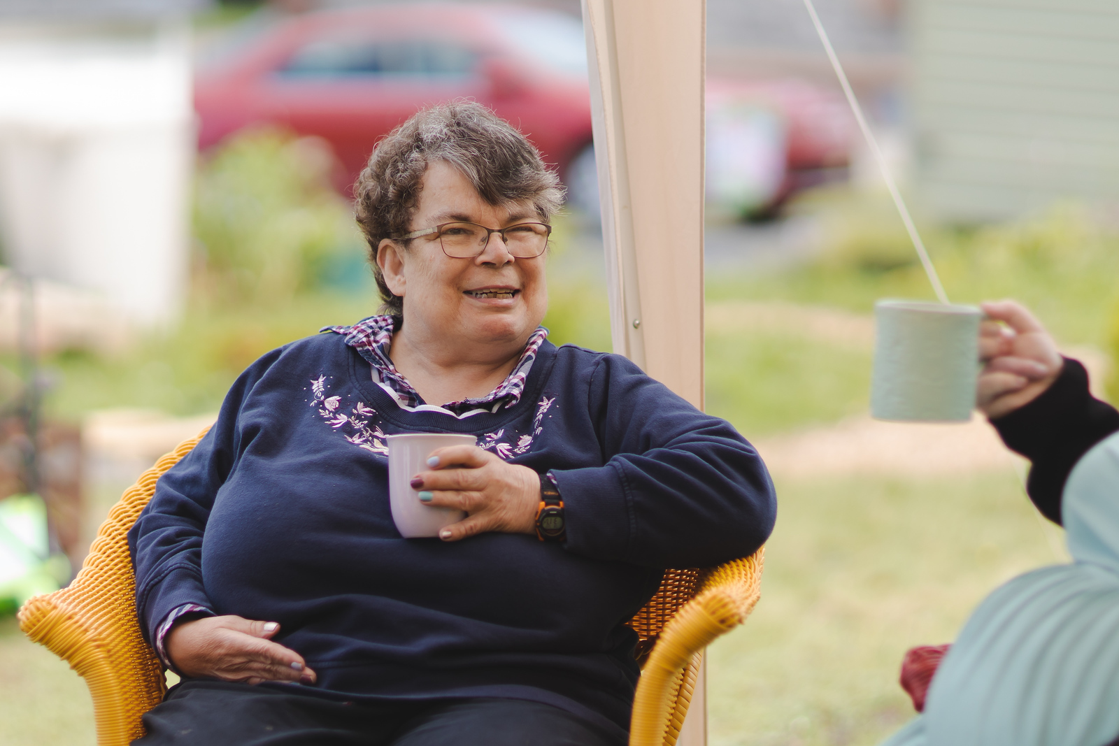 McKim house - woman having tea with friends outside.
