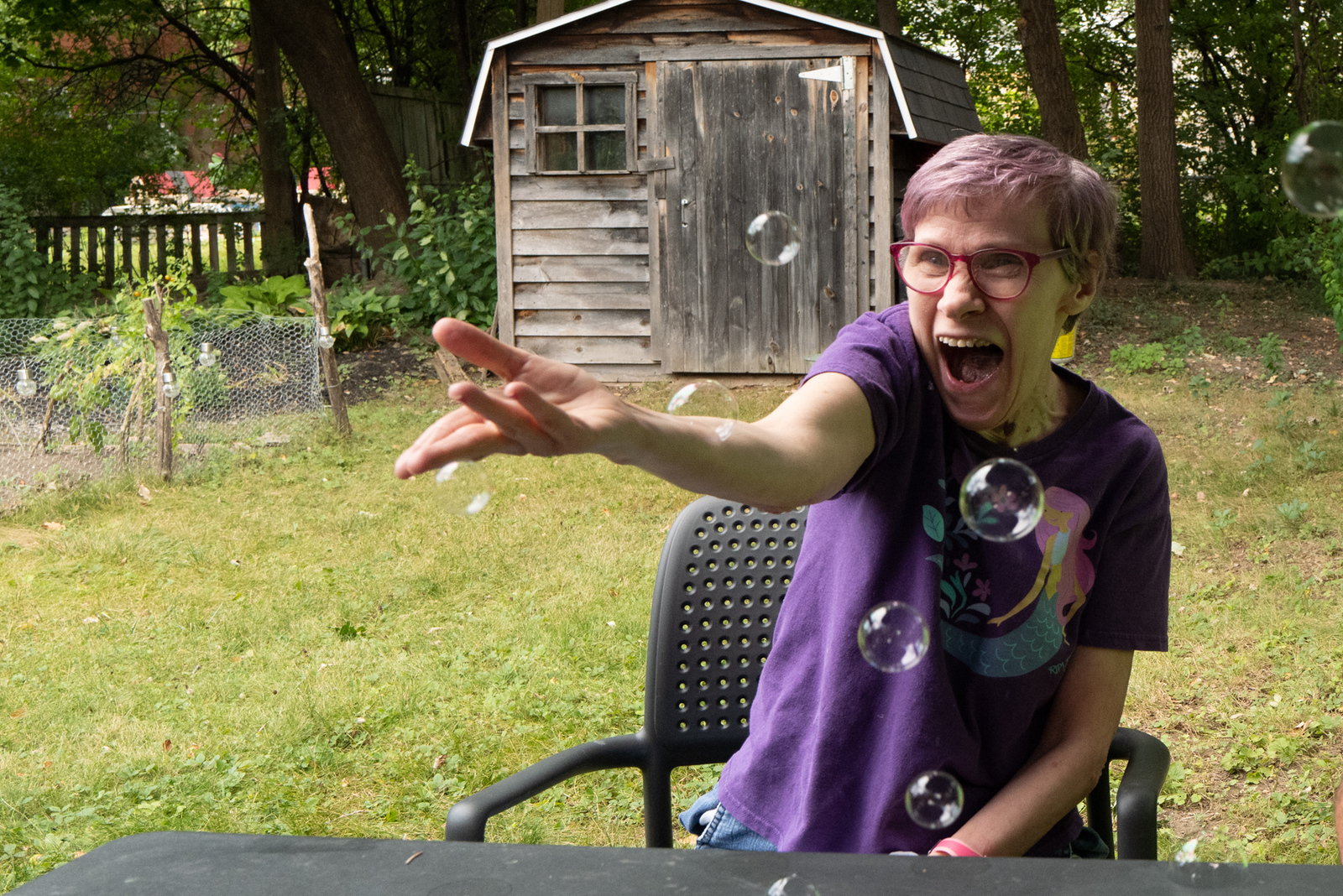 A woman catching bubbles