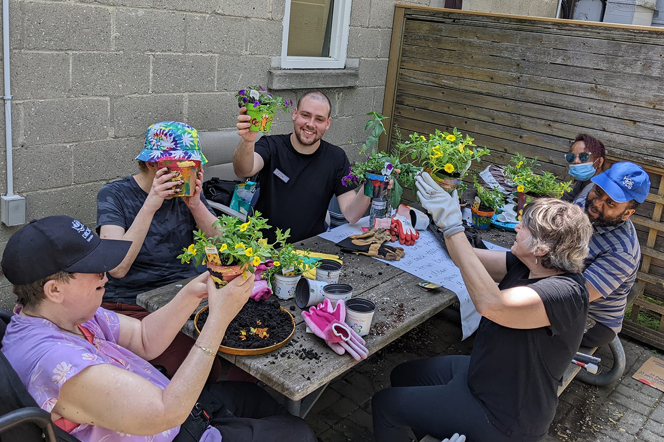 Toromnto - Community members outside around a picnic table