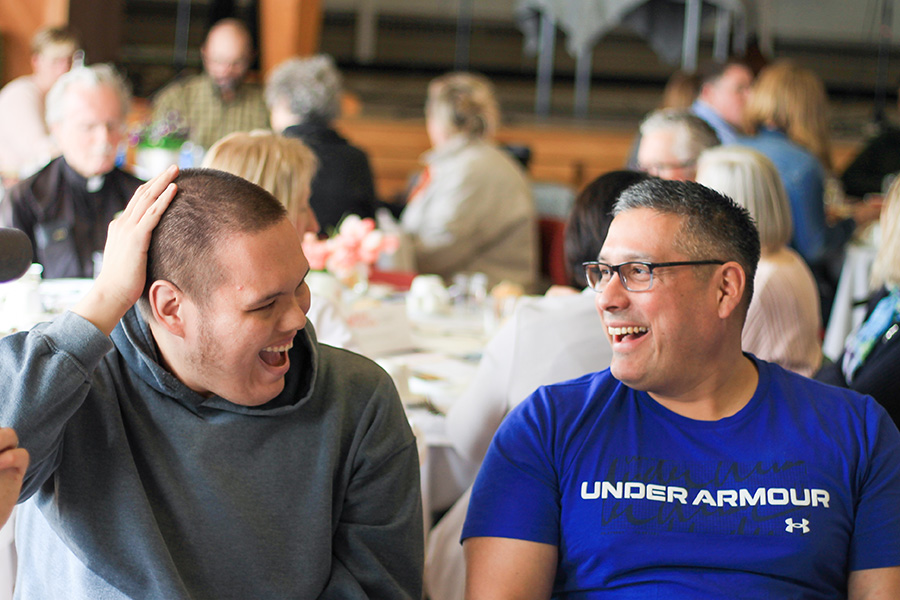 Two men indoors enjoying a conversation